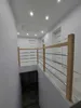 A hallway with a staircase railing. Produktbild-Vorschau