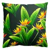 A pillow with a tropical bird of paradise flower and leaf pattern on a dark background. Produktbild-Vorschau