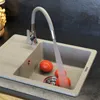 A kitchen sink with a faucet running water over tomatoes. Anteprima dell’immagine prodotto
