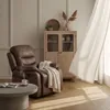 A cozy living room scene with a brown leather recliner, a coffee table with a book and mug, and a wooden cabinet. Anteprima dell’immagine prodotto
