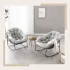Two rocking chairs with cushions are placed in a room with a concrete wall and a window. Produktbild-Vorschau