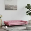 A pink dog sofa is placed on a rug in a living room, with a plant and a dog bowl nearby. Podgląd zdjęcia produktu