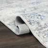 A close-up view of a rolled-up rug on a dark wooden floor. Podgląd zdjęcia produktu