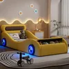 A child's bedroom with a yellow car-shaped bed, toys, and decorative star lights. Produktbild-Vorschau