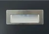 A close-up view of a brushed metal recessed handle on a dark gray surface. Anteprima dell’immagine prodotto