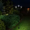 A solar-powered lamppost with three lights illuminates a garden at night. Produktbild-Vorschau