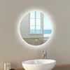 A round LED mirror with a light ring is mounted on a wall above a sink in a bathroom. Produktbild-Vorschau