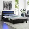 A bedroom scene featuring a black upholstered bed with blue LED lighting. Produktbild-Vorschau