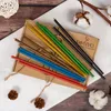 A set of colorful beeswax candles arranged on a cardboard box, with decorative elements like cotton bolls and pinecones. Náhľad obrázku produktu