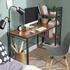 A desk setup in a room with a desk, monitor, lamp, and chair. Produktbild-Vorschau