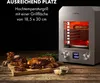 A high-temperature grill with steaks and side dishes on a wooden table. Produktbild-Vorschau