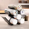 A wine rack holding several cylindrical containers, likely for spices or tea, on a countertop. Produktbild-Vorschau