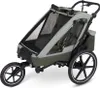 A product shot of a green and gray bicycle trailer for children. Produktbild-Vorschau