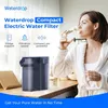 A woman in a bathrobe drinks water from a bottle next to a Waterdrop electric water filter. Podgląd zdjęcia produktu