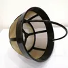 A reusable coffee filter basket with a black plastic frame and a tan mesh filter. Produktbild-Vorschau