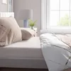 A close-up view of bedding on a bed, with pillows and a duvet cover. Produktbild-Vorschau