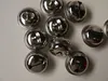 A collection of silver-colored jingle bells arranged on a light gray surface. Produktbild-Vorschau