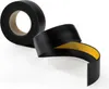 A roll of black tape with a yellow adhesive strip is shown against a white background. Part of the tape is unrolled and curved. Produktbild-Vorschau