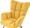 A close-up view of a yellow upholstered armchair with tufted detailing. Náhled obrázku produktu