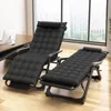 Two black reclining chairs are set up in a room with a desk and a large window overlooking a city. Voir les images du produit