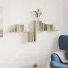 A modern wooden wall shelf unit with books and decorative items mounted on a white wall, with a blue armchair in the foreground. Podgląd zdjęcia produktu