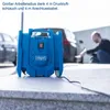 A person is using a blue air compressor to inflate a car tire. The compressor is on a stone surface, with cars in the background. Produktbild-Vorschau