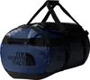 A blue duffel bag with black straps and accents, featuring the North Face logo. Voir les images du produit