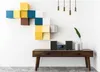 A modern living room setup with a stereo system on a wooden console table and colorful wall shelves. Produktbild-Vorschau