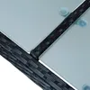Close-up view of the corner of a poly-rattan furniture set with glass tabletop. Produktbild-Vorschau