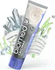 A tube of BIOMED CALCIMAX toothpaste is shown in a dynamic, artistic composition with crystals and plant elements. Produktbild-Vorschau