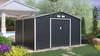 A dark gray garden shed with a white trim and door, set in a garden with flowers and a paved walkway. Náhľad obrázku produktu