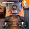 A woman is lying in bed, relaxed, with an orange glow emanating from a heating pad beneath her. Icons and text suggest benefits for pain, sleep, and tension. Náhled obrázku produktu