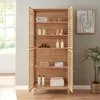 A wooden cabinet with slatted doors, filled with towels and toiletries, placed in a room with a window and a plant. Produktbild-Vorschau