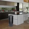 A modern kitchen with a black automatic trash can in the foreground. Produktbild-Vorschau
