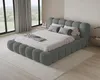 A bedroom scene with a large bed, large windows with curtains, and a rug. Voir les images du produit