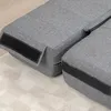 A close-up view of two gray upholstered sofa modules on a white rug. Náhled obrázku produktu
