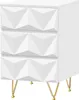 A white nightstand with a geometric textured front and gold legs, shown from a front-diagonal angle against a white background. Produktbild-Vorschau