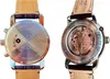 Two views of a watch, showing the back case with engravings and the movement through a transparent case back. Voir les images du produit