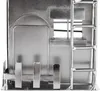 A close-up view of a silver metal figurine of a house with a ladder and some decorative elements. Náhľad obrázku produktu