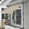 An outdoor patio scene with a retractable awning extended over a sliding glass door. Anteprima dell’immagine prodotto