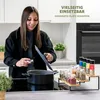 A woman is cooking in a modern kitchen, with a spice rack in the foreground. Voir les images du produit