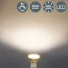 A spotlight bulb emitting a bright beam of light against a neutral background, with feature icons at the top. Voir les images du produit