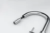 A close-up studio shot of a chrome kitchen faucet with a pull-out spray head against a white background. Podgląd zdjęcia produktu