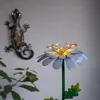 A decorative metal flower with LED lights and a metal gecko decoration on a wall. Produktbild-Vorschau