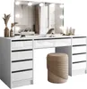 A white vanity table with a mirror and lights, a beige stool, and decorative items. Náhled obrázku produktu