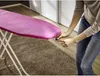 A person is adjusting the cover of an ironing board. Produktbild-Vorschau
