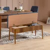 A wooden bench with storage is placed in a dining room setting, next to a dining table and chairs. Voir les images du produit