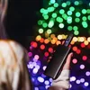 A person holding a black electronic device with colorful bokeh lights in the background. Náhled obrázku produktu