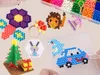 A collage of various crafts made from colorful beads, including a flower, a lion, a Christmas tree, a car with a dolphin, and a rabbit design. Náhľad obrázku produktu