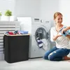 A woman and child are doing laundry in a laundry room. Voir les images du produit